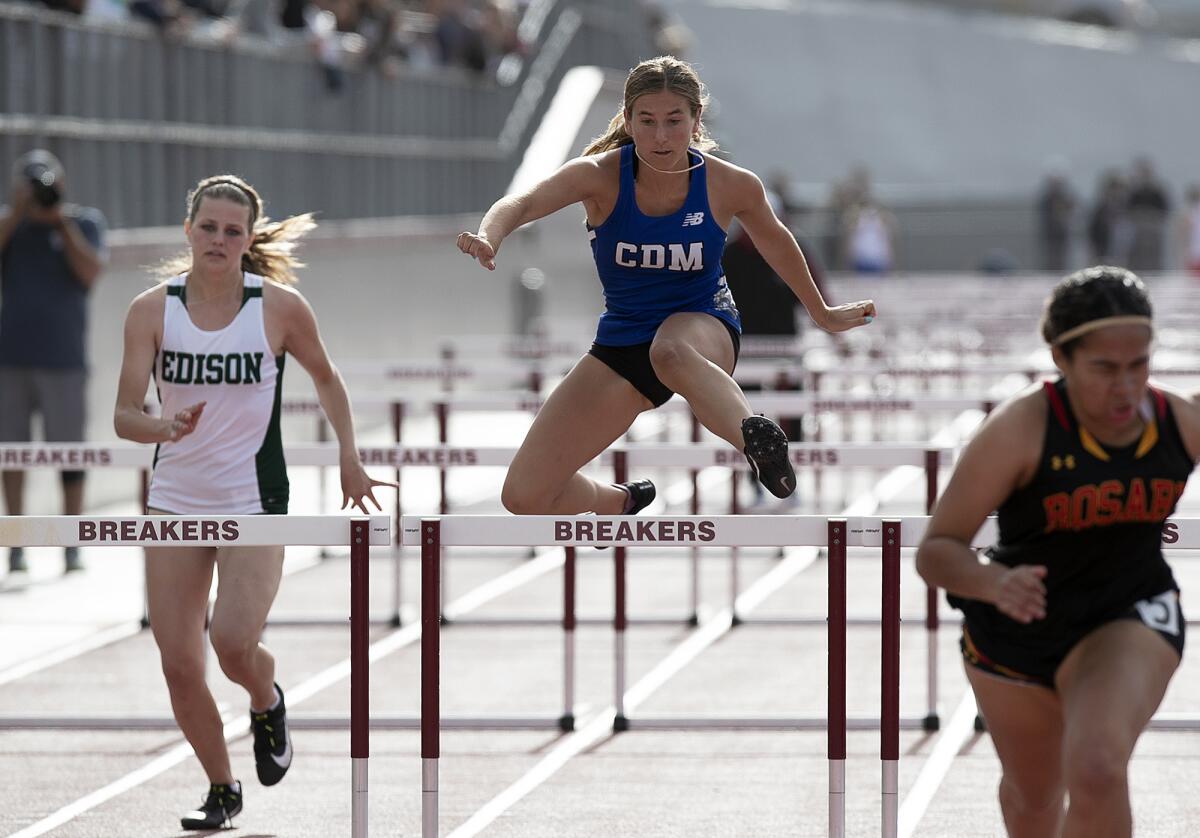 Corona del Mar's Ashley Riba, center, and Edison's Rebecca Bradbury, left, compete in the girls' 100-meter hurdles.