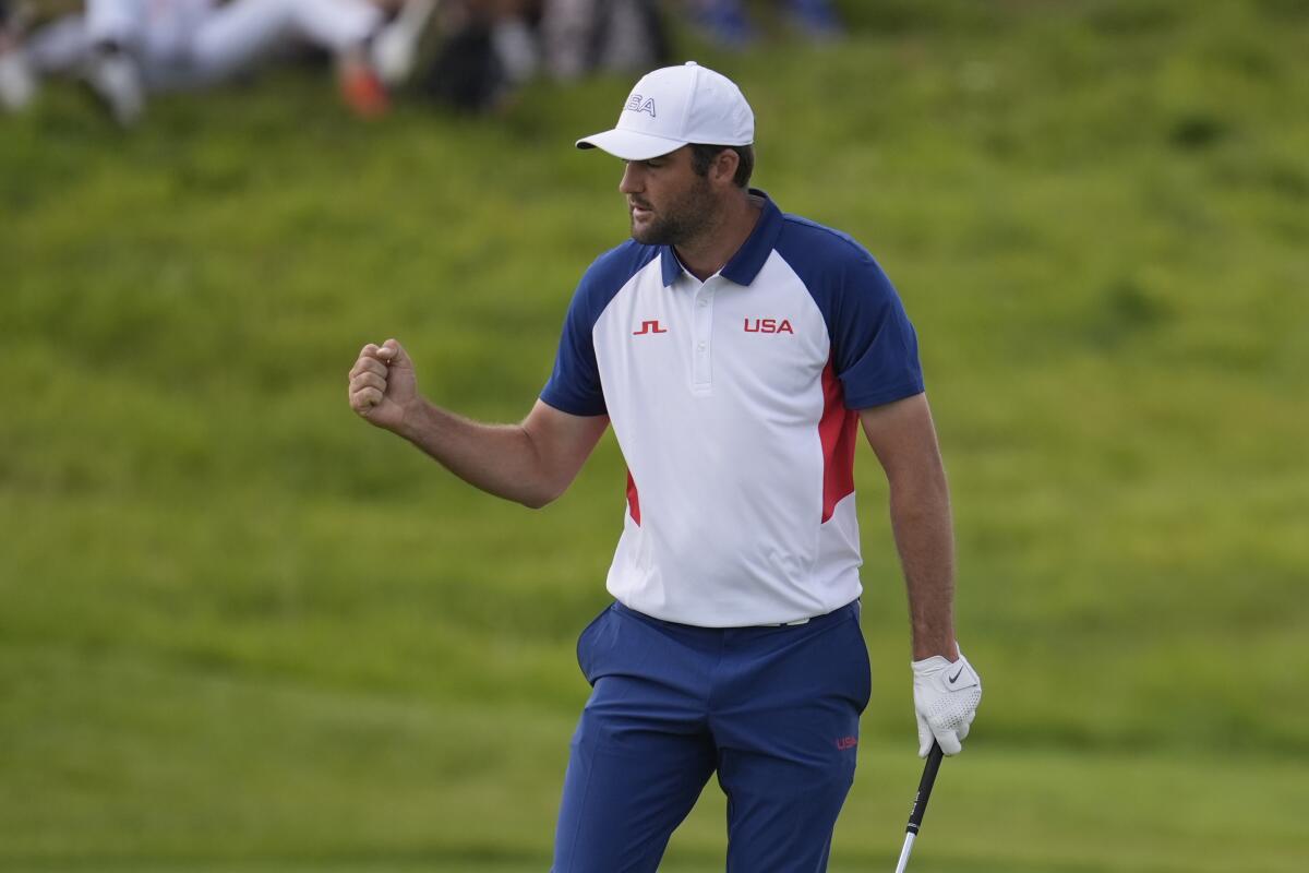 U.S. golfer Scottie Scheffler celebrates after making a birdie putt on the second green during the final round.