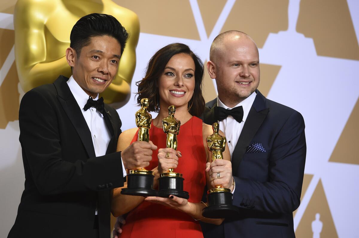 Kazuhiro Tsuji, from left, Lucy Sibbick, and David Malinowski, winners of the award for best makeup and hairstyling for "Darkest Hour."