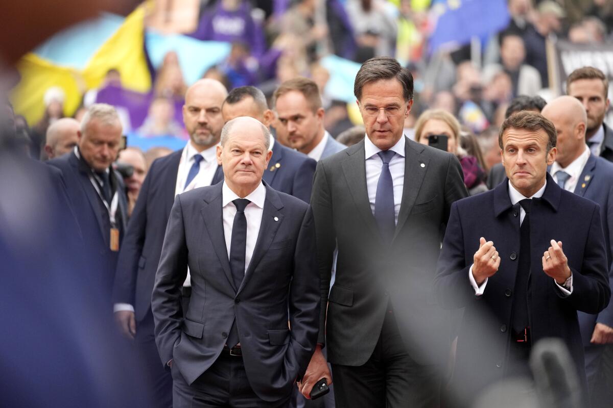 Germany's Chancellor Olaf Scholz, Netherland's Prime Minister Mark Rutte and French President Emmanuel Macron.