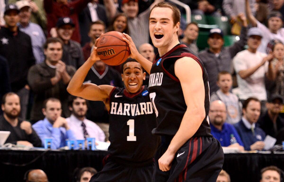 Harvard guard Siyani Chambers (1) and forward Laurent Rivard begin to celebrate after defeating New Mexico, 68-62, on Thursday.