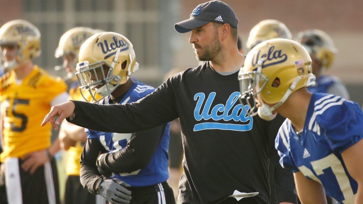 UCLA football's Jimmie Dougherty instructs receivers during spring practice April 6.