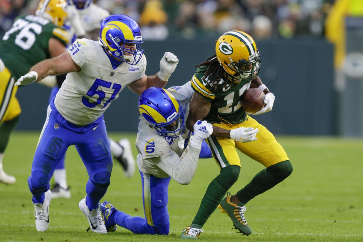 Green Bay Packers receiver Davante Adams tries to get past Rams Jalen Ramsey (5) and Troy Reeder.