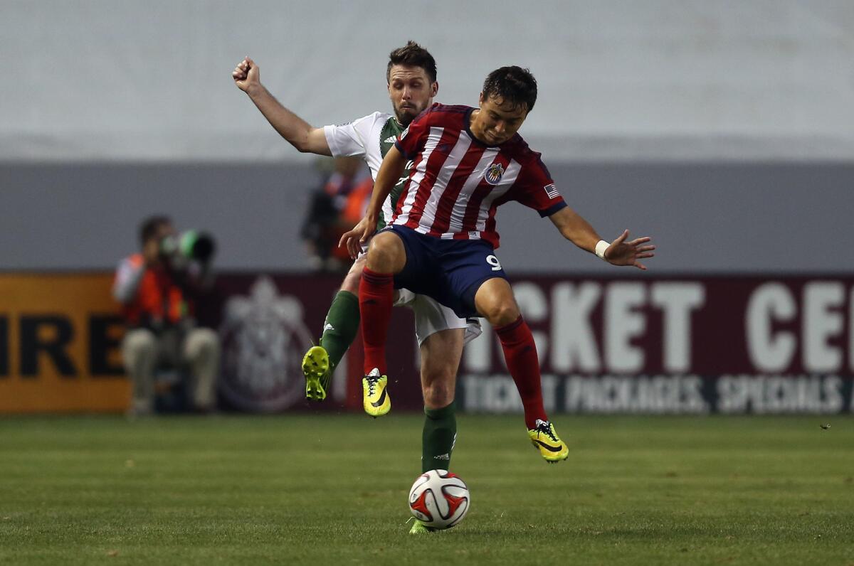 Chivas USA's Erick Torres, shown in front of Portland's Danny O'Rourke, has nine goals this season, the third-highest in Major League Soccer.