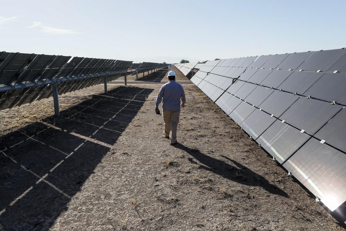 A site supervisor inspects panels at a solar farm in California's Imperial Valley, near the U.S.-Mexico border.