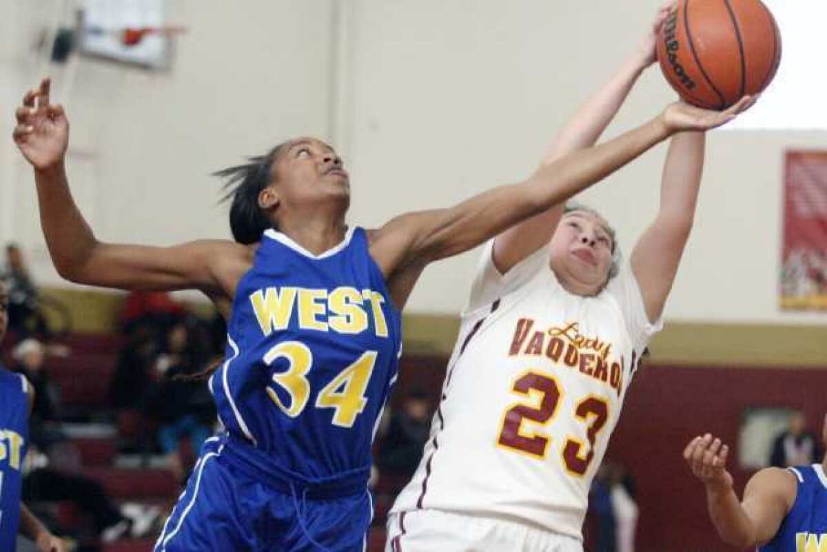 West Los Angeles' Shandrea Fortune, left, attempts to steal the ball from GCC's Bianca Galicia.