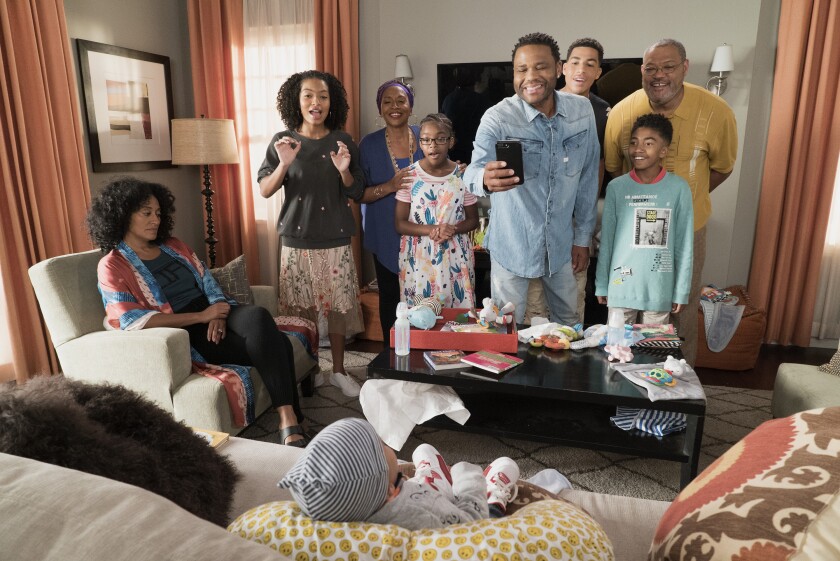 People gather in a living room.