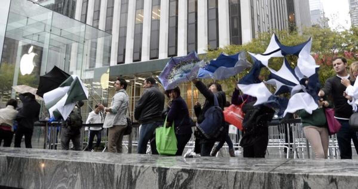 The iPhone 5s has been on sale nearly two months, but people are still lining up for it at the company's flagship store in New York.