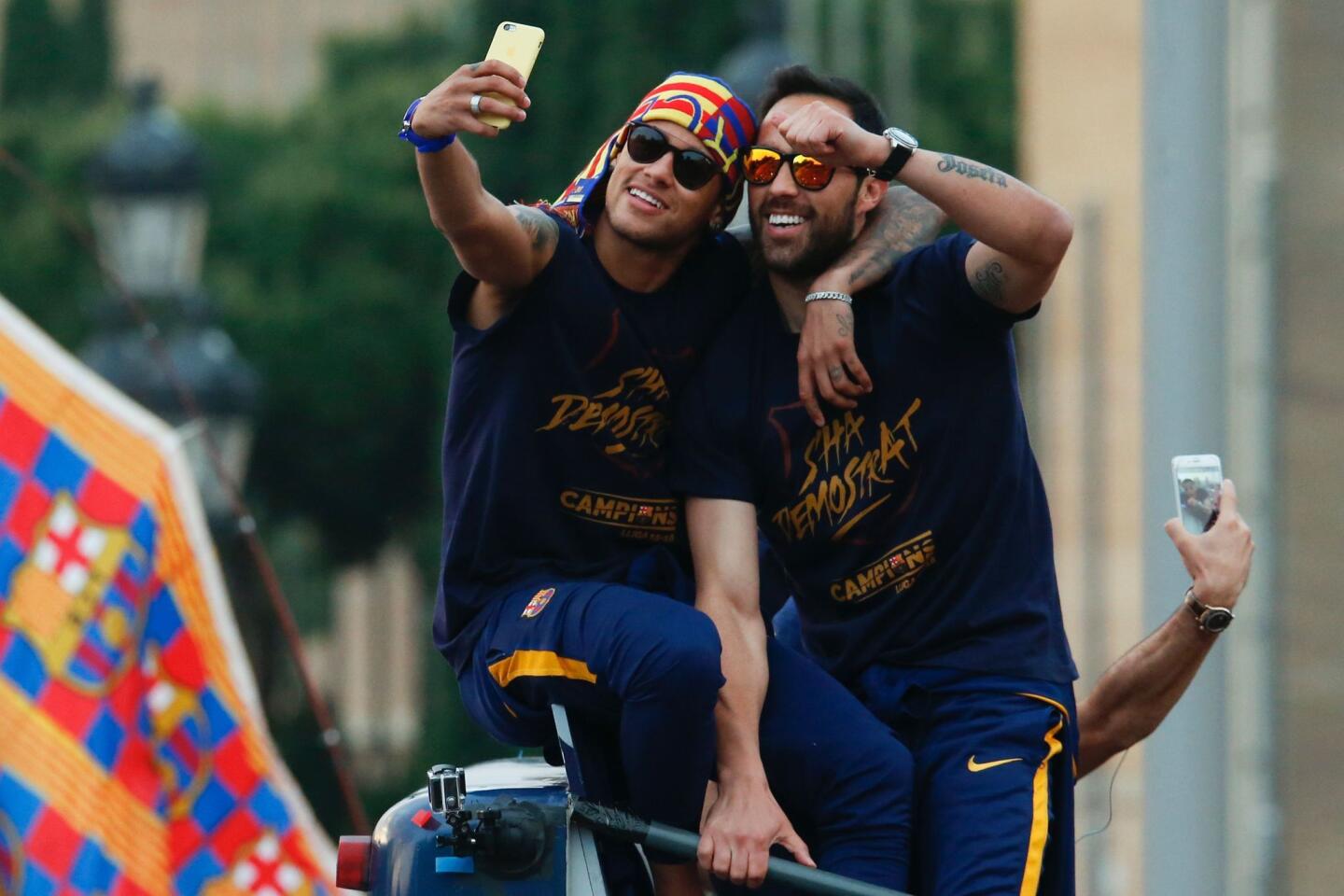 Barcelona's Brazilian forward Neymar (L) and Barcelona's Chilean goalkeeper Claudio Bravo take a selfie photo as they parade with their team on a bus through the streets of Barcelona to celebrate their 24th La Liga title, in Barcelona, on May 15, 2016 Barcelona sealed their 24th La Liga title on May 14, 2016 at Granada to hold off Real Madrid's late-season surge. / AFP PHOTO / PAU BARRENAPAU BARRENA/AFP/Getty Images ** OUTS - ELSENT, FPG, CM - OUTS * NM, PH, VA if sourced by CT, LA or MoD **