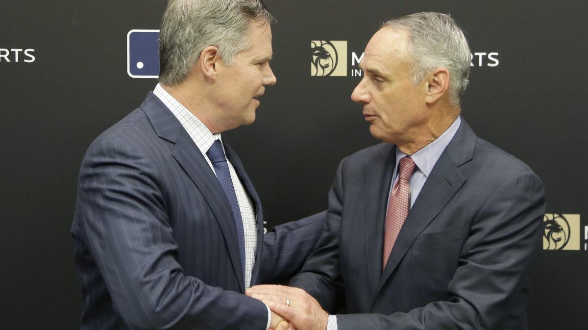 MGM Resorts CEO James Murren, left, and MLB Commissioner Rob Manfred shake hands after a news conference at MLB headquarters in New York on Tuesday.