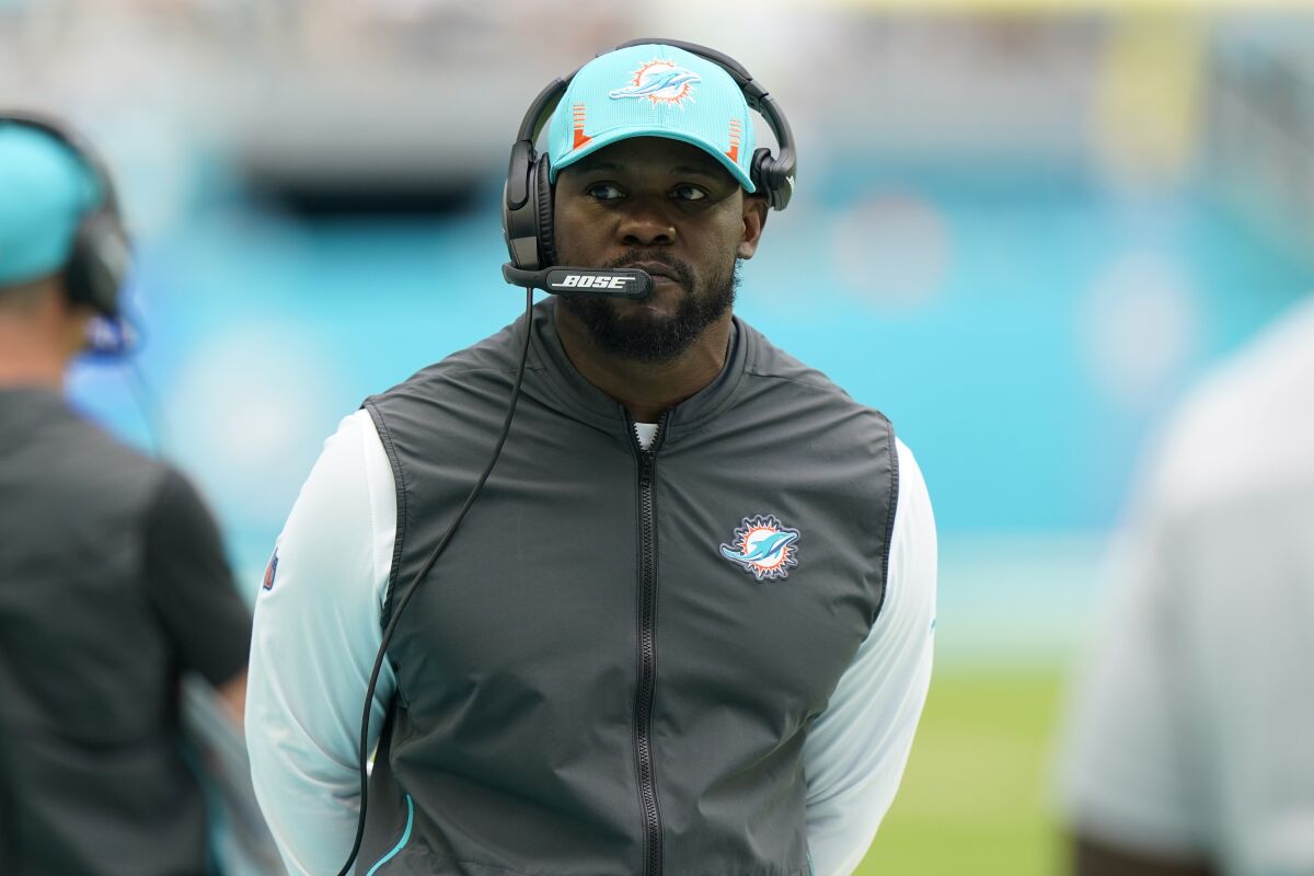 Miami Dolphins coach Brian Flores watches from the sideline.