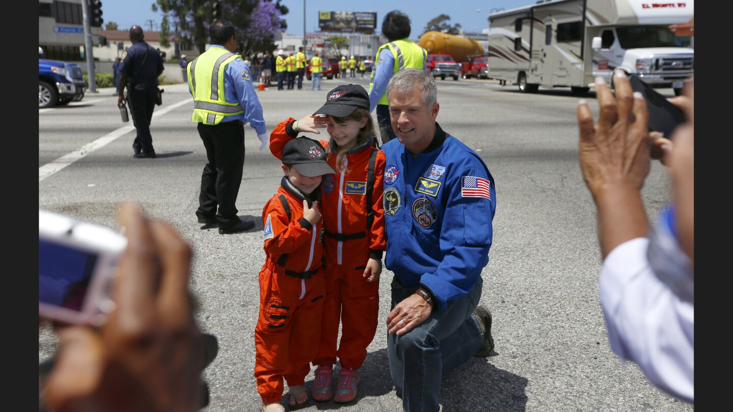 Kyle Bice, 5, and his sister Sydney Bice, 6, both of Lakewood, take a photo with astronaut Steve Swanson in Inglewood as the ET-94 space shuttle external tank travels across Los Angeles to its new museum home.