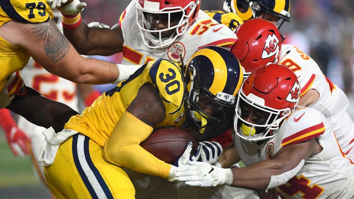 Chiefs defenders stop Todd Gurley after a three-yard gain during the second quarter Monday night.