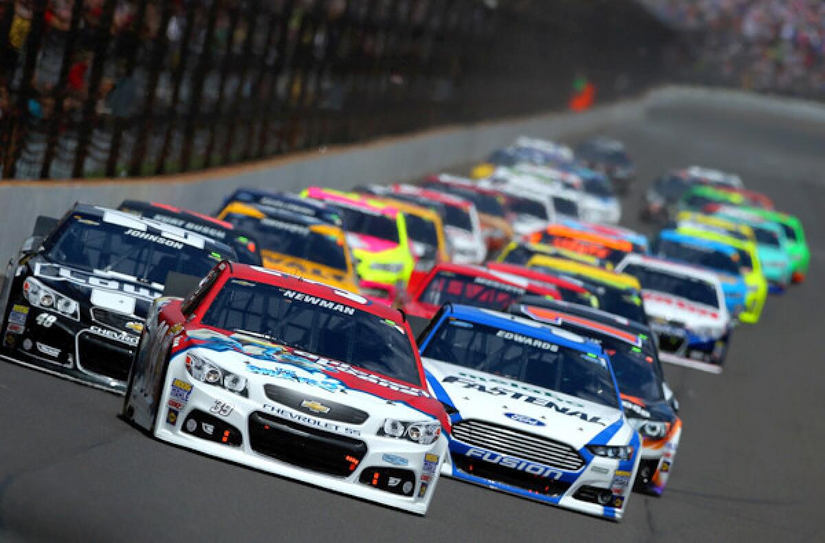 Ryan Newman, driver of the No. 39 Quicken Loans/The Smurfs Chevrolet, leads the field into turn one in the Brickyard 400 at Indianapolis Motor Speedway on Sunday.