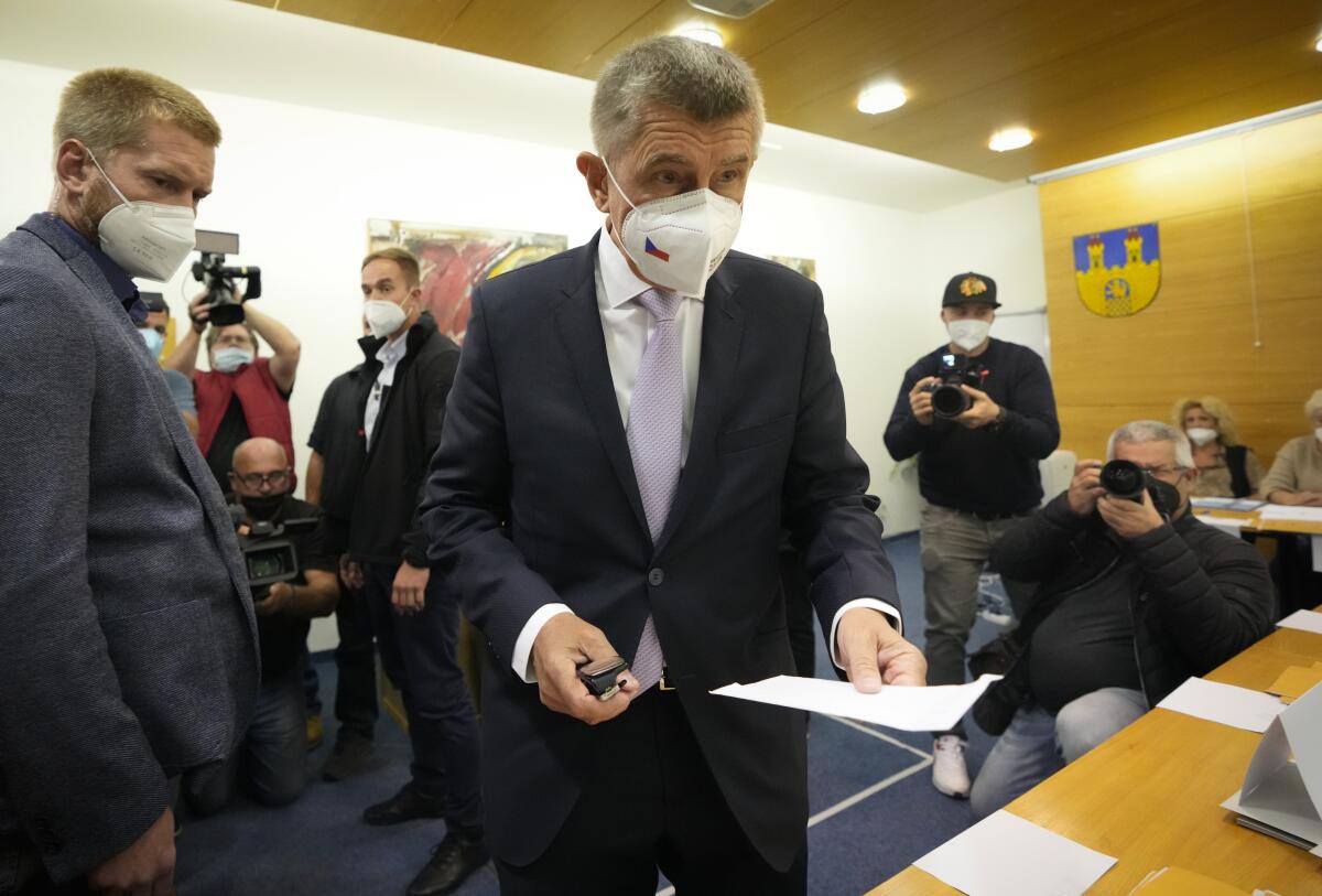 Czech Republic's Prime Minister Andrej Babis holds his ballot at a polling station.