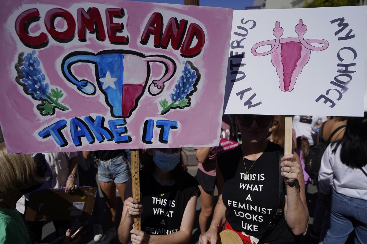 Demonstrators rally to demand continued access to abortion during a march in Los Angeles.