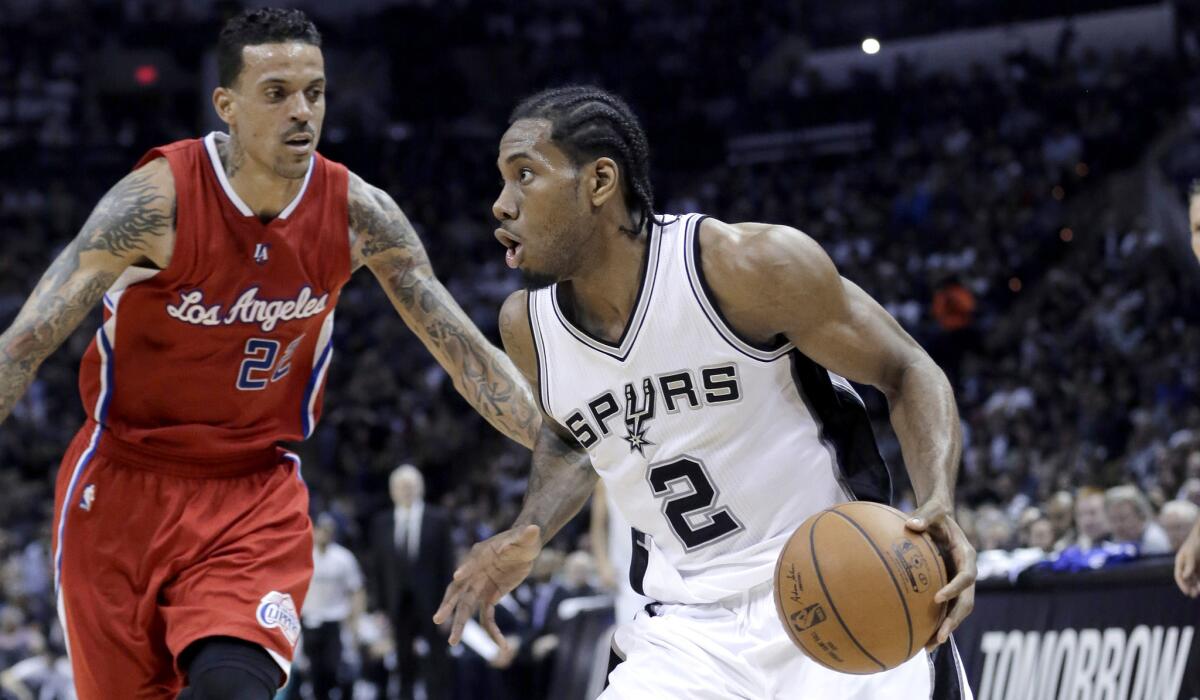 Spurs forward Kawhi Leonard drives the baseline against Clippers forward Matt Barnes in the second half of Game 3.