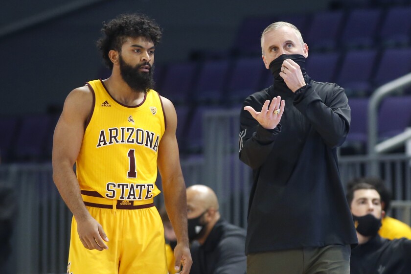 Arizona State head coach Bobby Hurley talks with Arizona State guard Remy Martin.