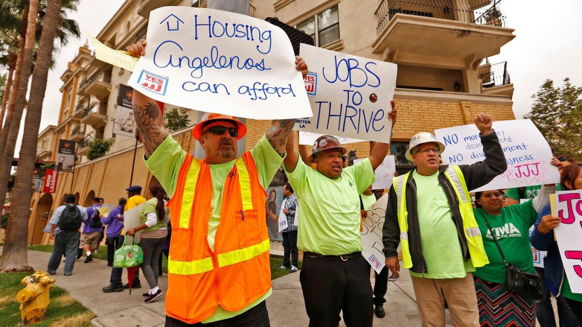 Construction workers hold up signs in Los Angeles in 2016.