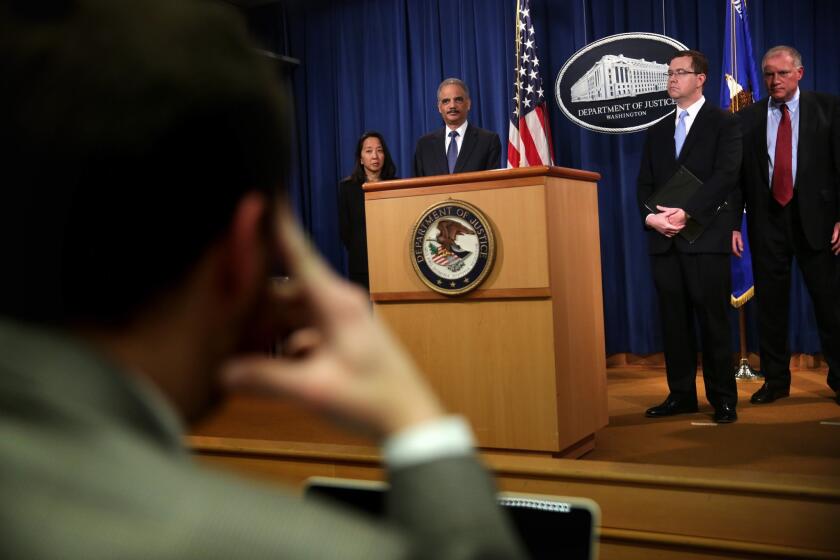 Atty. Gen. Eric Holder is pictured at a news conference to make a major financial fraud announcement Feb. 3, 2015, at the Justice Department in Washington.
