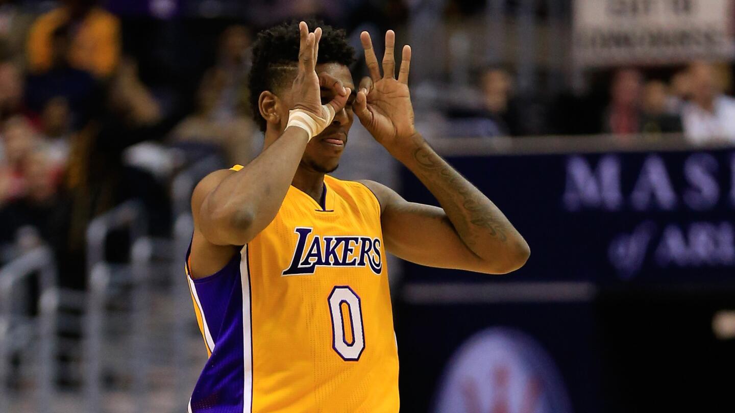 Lakers small forward Nick Young celebrates after hitting a shot during the first half of Wednesday's game against the Washington Wizards.