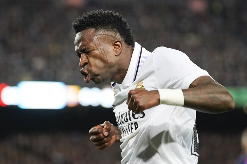 Real Madrid's Vinicius Junior celebrates after his team's first goal during the Spanish La Liga soccer match between Barcelona and Real Madrid at Camp Nou stadium in Barcelona, Spain, Sunday, March 19, 2023. (AP Photo/Joan Mateu)