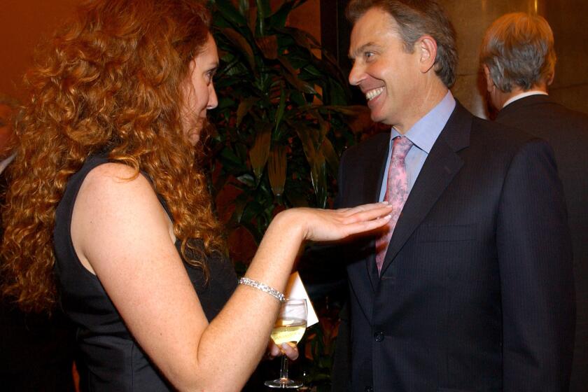 Former British Prime Minister Tony Blair with Rebekah Brooks, ex-chief executive of News International and a defendant in a phone hacking trial.