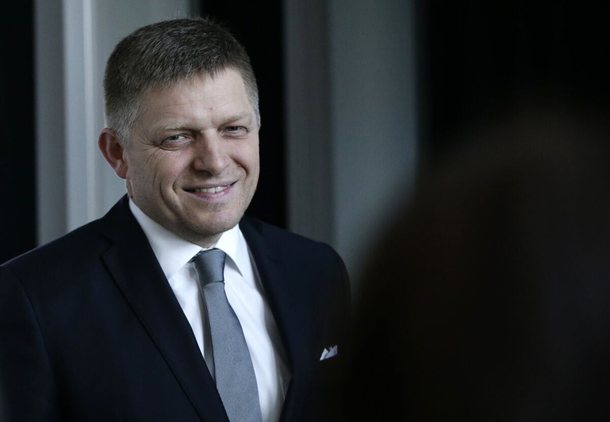 FILE - In this Sunday, March 6, 2016 file photo, Robert Fico, the then chairman of the SMER-Social Democracy, smiles after a TV debate after Slovakia's general elections in Bratislava, Slovakia. On Wednesday April 20, 2022, Slovakia's police said that former Prime Minister Robert Fico was under investigation, facing unspecified criminal charges. Police said in a brief statement Fico's former Interior Minister Robert Kalinak have been also charged in the same case. Police immediately didn't offer any more details. (AP Photo/Petr David Josek, File)