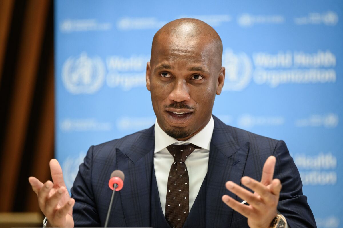 Football legend Didier Drogba delivers a speech after he as been appointed as the World Health Organization's Goodwill Ambassador for Sport and Health, at the WHO headquarters in Geneva, Switzerland, on Wednesday, 18 October 2021. (Fabrice COFFRINI/Keystone via AP)