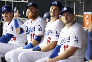 Los Angeles, CA - October 11: Los Angeles Dodgers first baseman Freddie Freeman, from left, sits in the dugout.