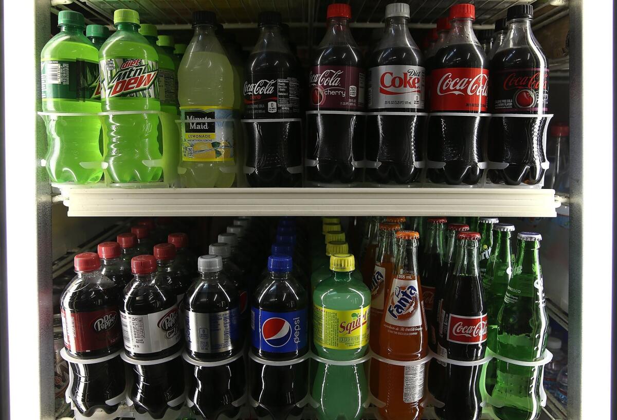 Bottles of soda are displayed at a convenience store in San Francisco. The Food and Drug Administration wants to include information about added sugar on food labels.