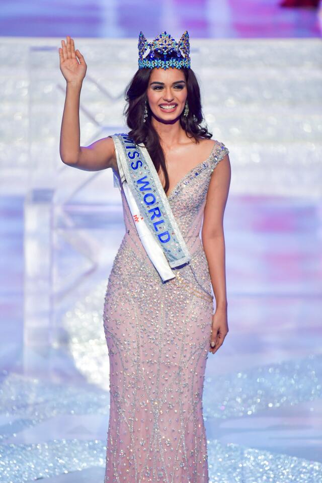 Miss India Manushi Chhillar waves onstage after being crowned Miss World at the Miss World pageant in Sanya