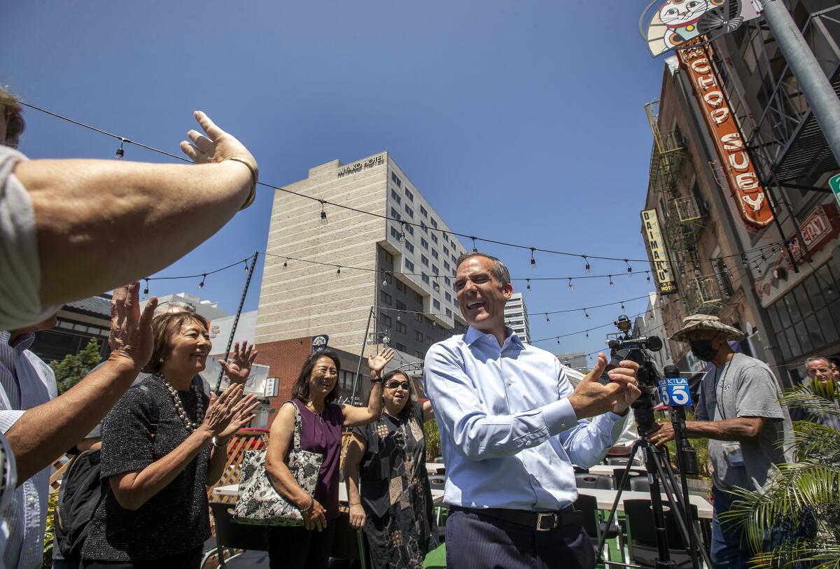 Mayor Eric Garcetti interacts with store owners and others who work in L.A.'s Little Tokyo.