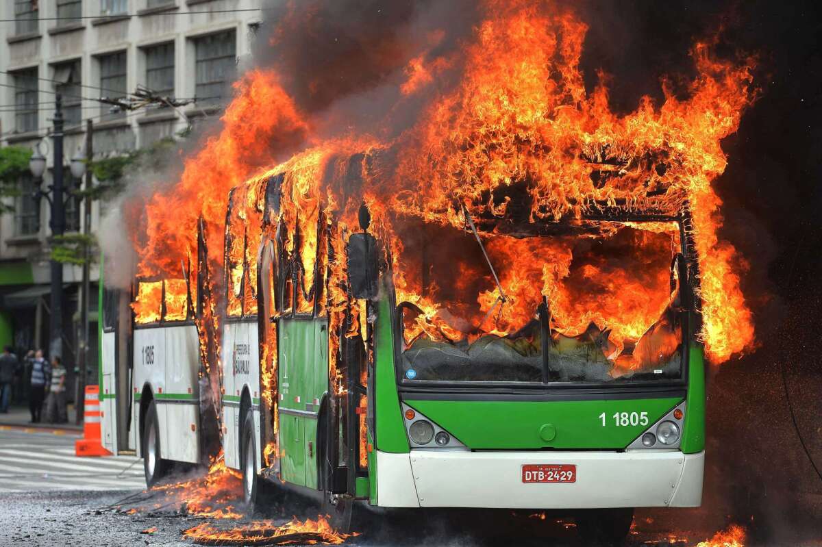 A bus burns Tuesday after being set ablaze during clashes between riot police and people squatting in a building in Sao Paulo, Brazil.