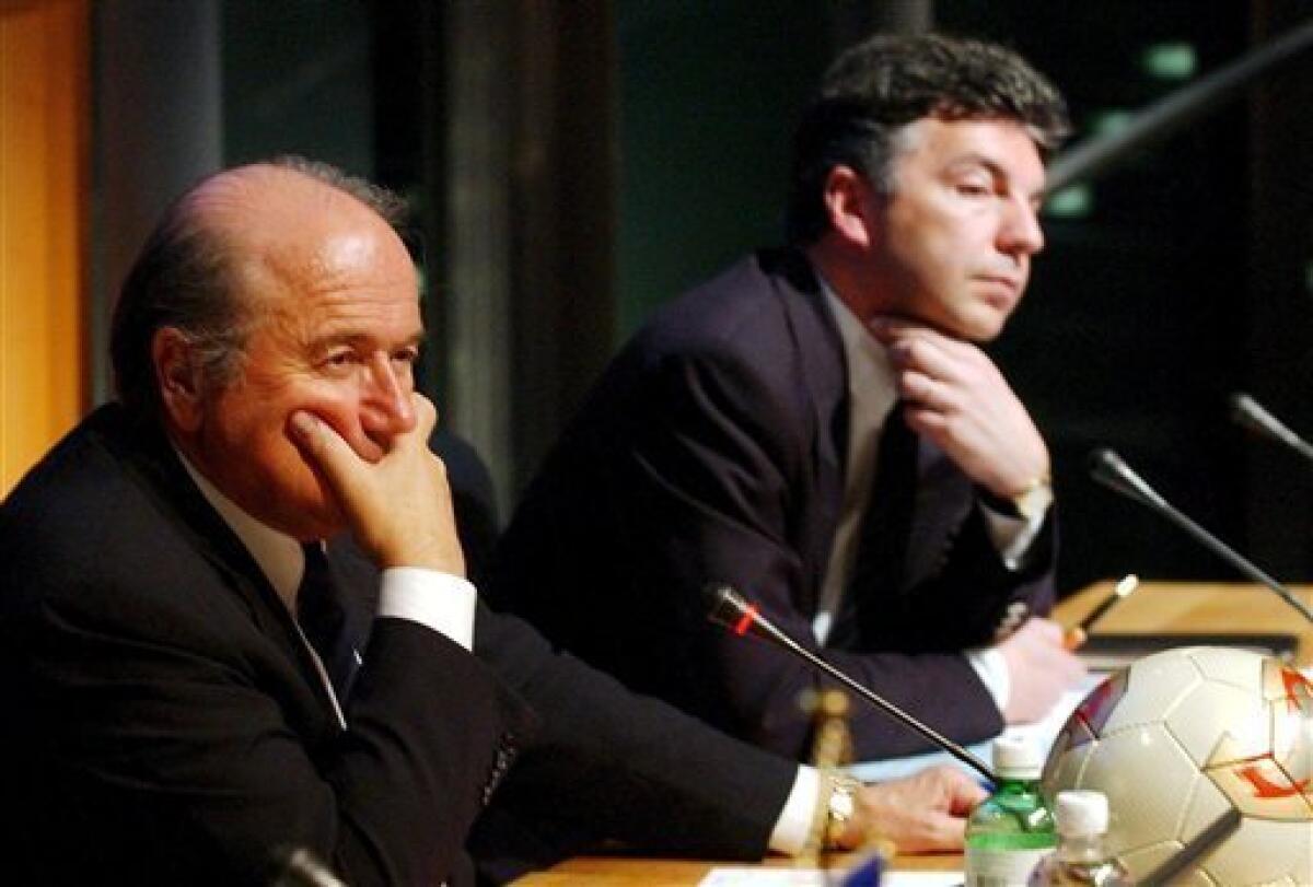 FILE - THE May 3, 2002 file photo shows FIFA President Joseph Blatter, left, and then secretary general Michel Zen-Ruffinen attending a press conference in Zurich, Switzerland. FIFA widened its probe into alleged World Cup bidding corruption on Monday after a former leading administrator reportedly claimed two candidates have colluded to trade votes. FIFA said it has "immediately requested to receive all ... potential evidence," from Britain's Sunday Times newspaper regarding its reporting of comments from Michel Zen-Ruffinen, who was general secretary of football's world governing body for four years until 2002. (AP Photo/Keystone, Gartan Bally)