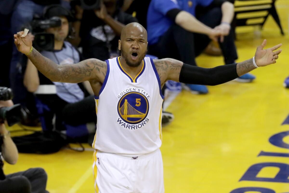 Marreese Speights celebrates after the Golden State Warriors scored against the Cleveland Cavaliers during an NBA Finals game in Oakland on June 19.
