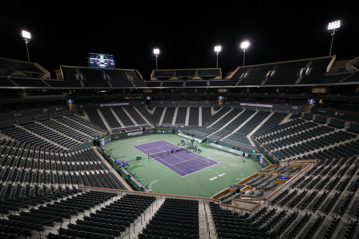 Courtmaster Jeffrey Brooker cleans the center court at the Indian Wells Tennis Garden.