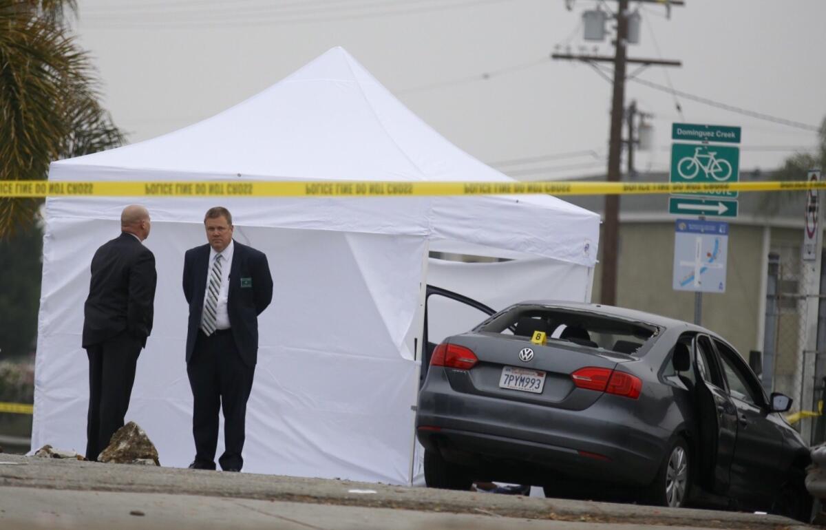 Investigators on the scene of a car-to-car shooting Sunday in Hawthorne.