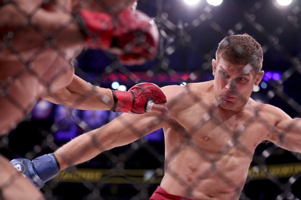 Brent Primus lands a kick against Michael Chandler during their lightweight title fight at Bellator NYC.