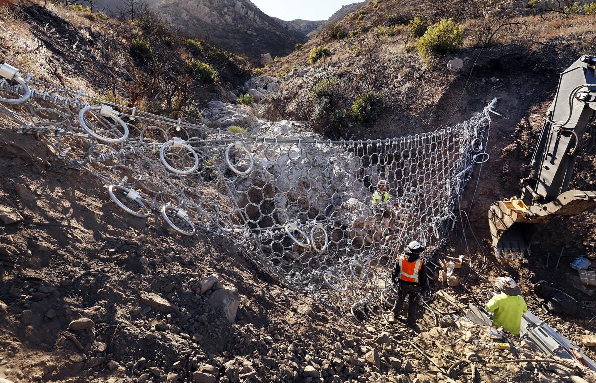 Crews worked to install one of five debris-flow barriers on Conejo Mountain.