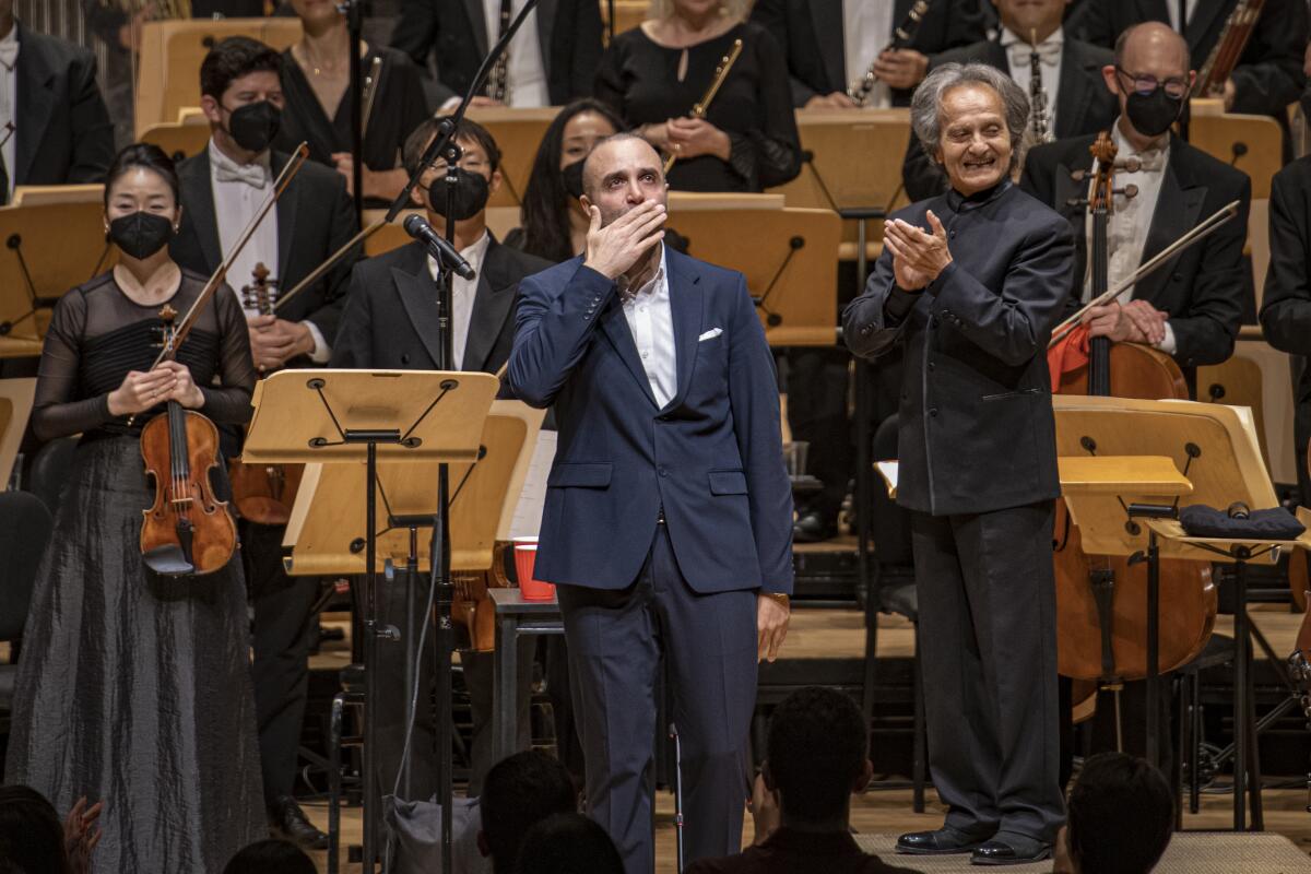 Iranian traditional singer Sina Sarlak, center, with conductor Shardad Rohani Saturday in Costa Mesa.