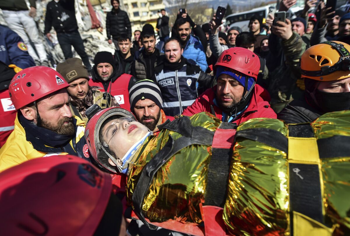 Rescuers carry Zeynep Polat, pulled out from a collapsed building 