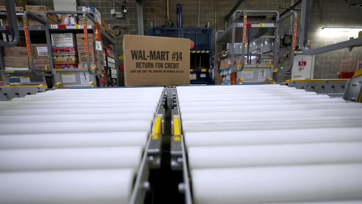 A box of merchandise is unloaded from a truck and sent along a conveyor belt at a Walmart Supercenter in Houston in 2018.