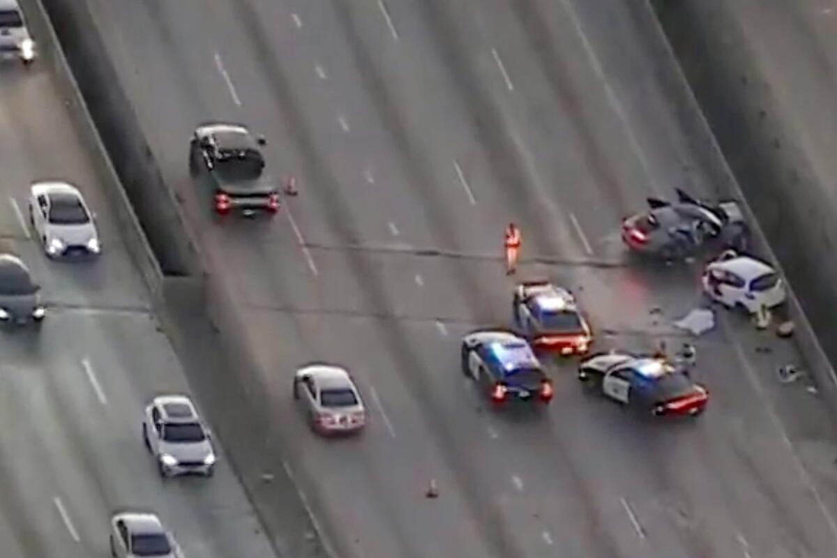 Aerial view of police at a crash scene on a freeway