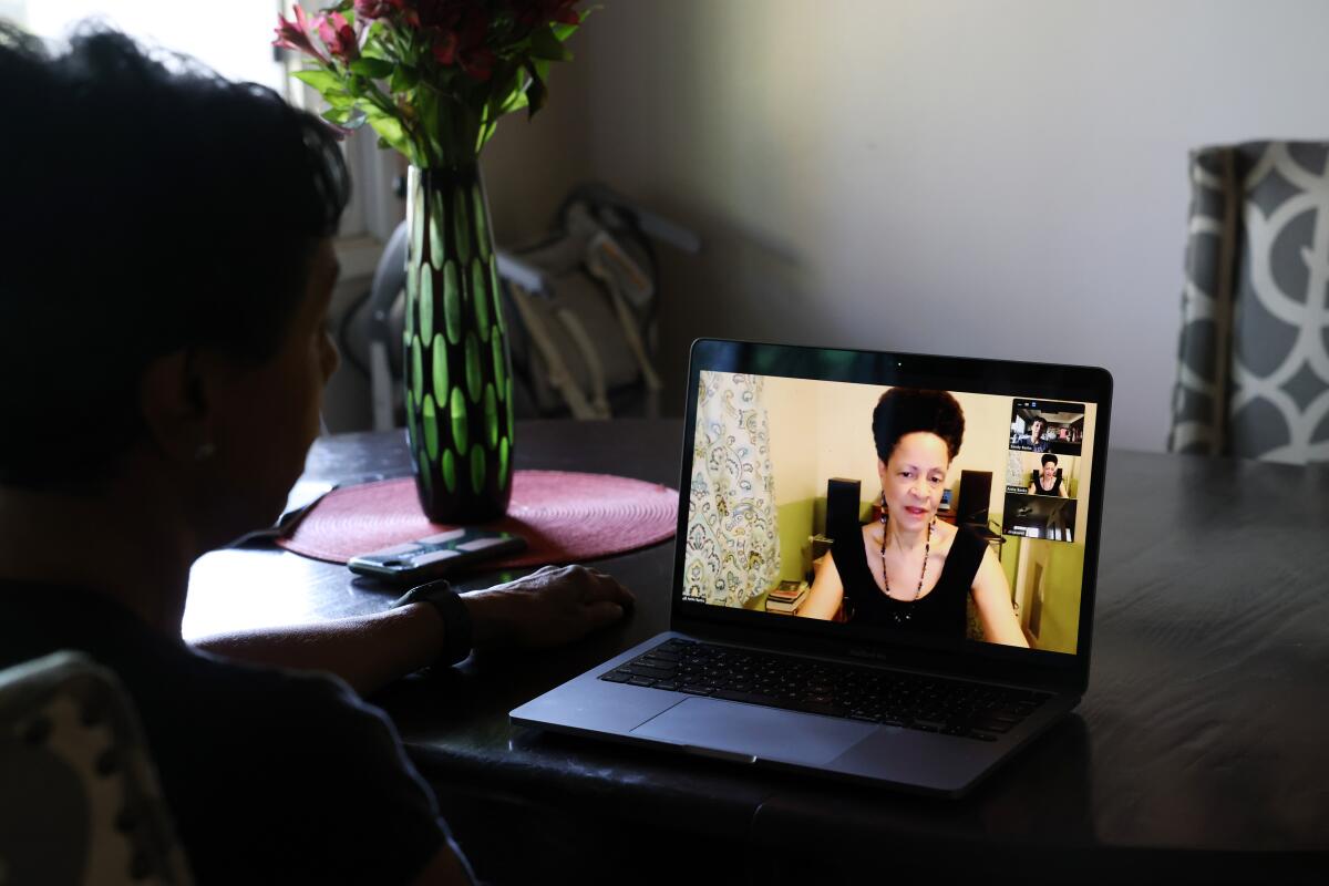 Sandy Banks talks to her sister, who is on her laptop screen in a video call