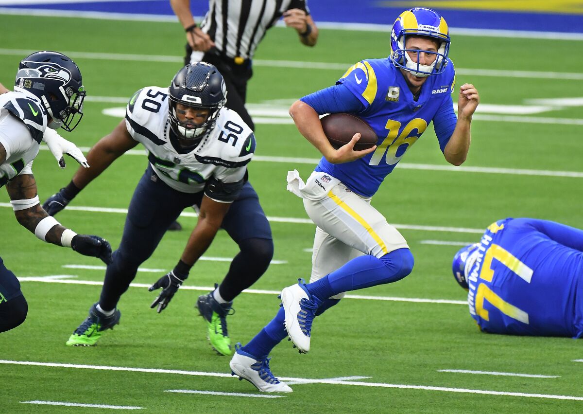 Rams quarterback Jared Goff scrambles away from the Seahawks' defense.