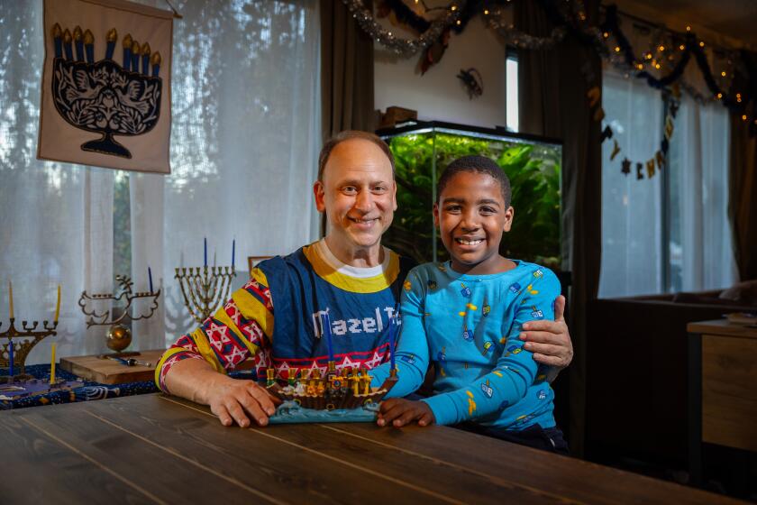 Studio City, CA - December 05: Adam Kulbersh, founder of Project Menorah, and his 6-year-old son Jack pose for a portrait on Tuesday, Dec. 5, 2023 in Studio City, CA. (Jason Armond / Los Angeles Times)