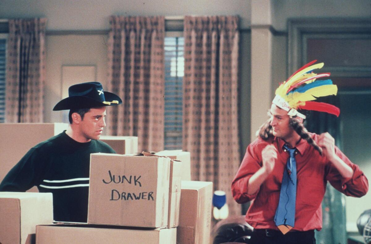Matt LeBlanc, wearing a black cowboy hat, and Matthew Perry film "Friends."