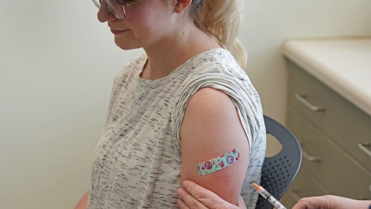 A nurse at the Utah County Health Department in Provo gives an MMR vaccine to a woman who has never been immunized before.
