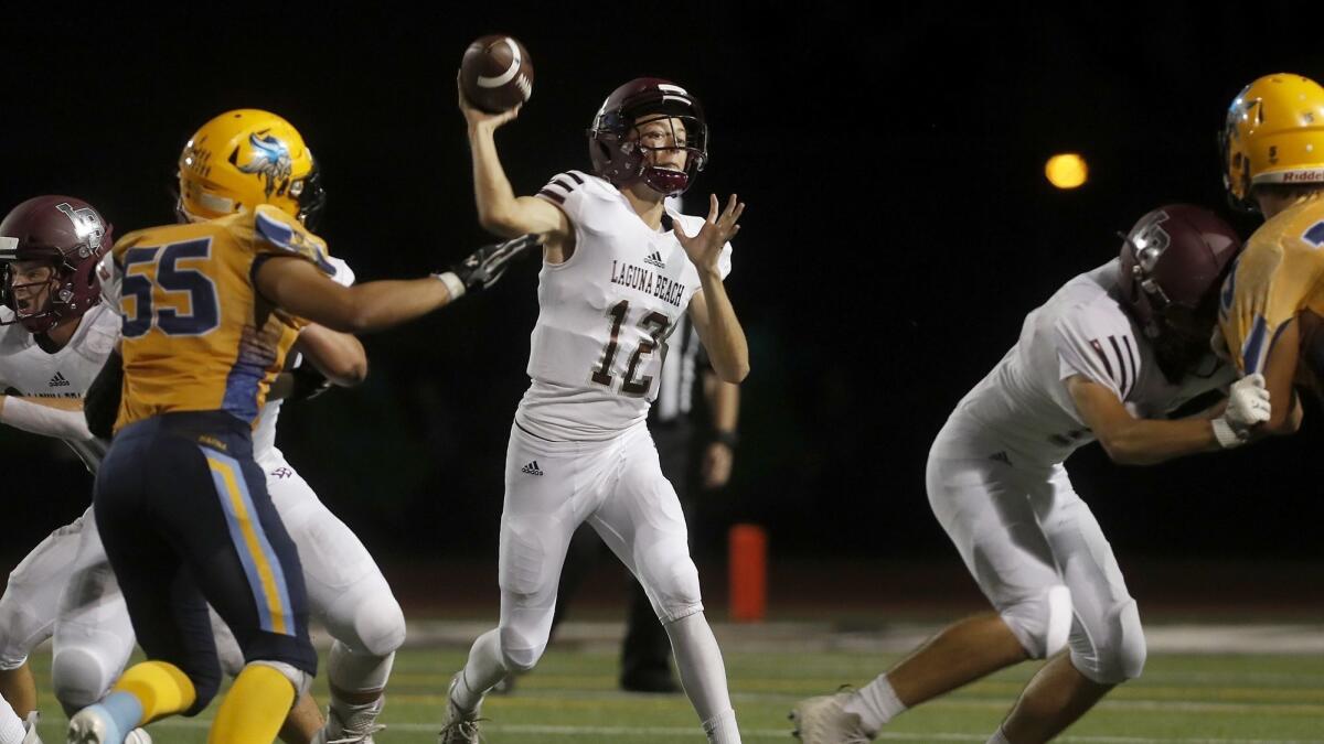 Laguna Beach High quarterback Andrew Johnson throws a pass against Marina during the first half of a nonleague game at Westminster High on Friday.